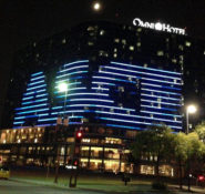 Windows of the Omni Hotel in Dallas lit in an arrangement to create the ASCE logo